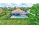 Aerial view of a home featuring a screened-in pool area and lush green landscaping at 7705 55Th E St, Ellenton, FL 34222