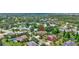 An aerial view of a home in a quiet neighborhood near a pond and lush greenery at 7705 55Th E St, Ellenton, FL 34222
