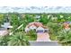 An aerial view of a gray home with lush green landscaping and mature trees surrounding the property at 7705 55Th E St, Ellenton, FL 34222