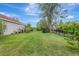 Spacious backyard featuring lush green grass and mature trees, perfect for outdoor activities and relaxation at 7705 55Th E St, Ellenton, FL 34222