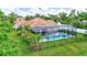 An aerial view showcases the screened-in pool and a beautifully landscaped backyard at 7705 55Th E St, Ellenton, FL 34222