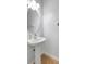 Updated powder room with a pedestal sink, white walls, and tiled floor at 7705 55Th E St, Ellenton, FL 34222