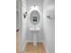 Updated powder room with a pedestal sink, white walls, and tiled floor at 7705 55Th E St, Ellenton, FL 34222