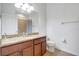 Bathroom featuring wood cabinets, granite countertop, and shower-tub combo at 7705 55Th E St, Ellenton, FL 34222