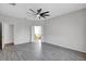 Neutral bedroom with a large window, ceiling fan, and grey, wood-look tile flooring at 7705 55Th E St, Ellenton, FL 34222