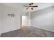 Neutral bedroom with a ceiling fan, carpet flooring, and standard closet with a double door at 7705 55Th E St, Ellenton, FL 34222