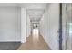 Inviting hallway with tile flooring leading to a bright living area and large glass sliding doors at 7705 55Th E St, Ellenton, FL 34222