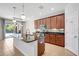 Elegant kitchen featuring a large island, stainless appliances, and pantry door at 7705 55Th E St, Ellenton, FL 34222