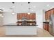 Large kitchen island with sink, dark countertops, and pendant lights at 7705 55Th E St, Ellenton, FL 34222