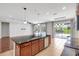Bright kitchen featuring an island with sink, stainless steel appliances, and views of the pool at 7705 55Th E St, Ellenton, FL 34222