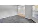 This living room features gray carpeting, a large window and an open floor plan at 7705 55Th E St, Ellenton, FL 34222