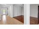 Open living room with wood floors and a view of the front entryway and hallway at 7705 55Th E St, Ellenton, FL 34222