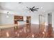 Open-concept living area featuring wood floors, a kitchen island, and modern lighting fixtures at 7705 55Th E St, Ellenton, FL 34222