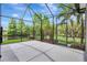 Screened patio with backyard view, enhanced by lush landscaping providing a serene outdoor living space at 7705 55Th E St, Ellenton, FL 34222