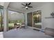 Relaxing screened patio featuring stylish furniture and a ceiling fan for comfortable outdoor living at 7705 55Th E St, Ellenton, FL 34222