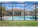 This backyard features a screened-in pool with a spa and outdoor seating with ample room for lounging at 7705 55Th E St, Ellenton, FL 34222