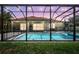 This backyard features a screened-in pool with a spa and outdoor seating, perfect for entertaining at 7705 55Th E St, Ellenton, FL 34222