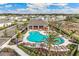 Aerial view of community pool and clubhouse amenities surrounded by lush landscaping at 821 157Th E Ct, Bradenton, FL 34212