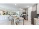 Modern kitchen with stainless steel appliances, granite countertops, and adjacent dining area at 825 157Th E Ct, Bradenton, FL 34212