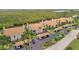 An aerial view of the condos and covered parking, with views of the bay and lush landscaping at 8710 54Th W Ave # 8710, Bradenton, FL 34210