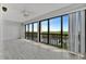 Screened-in balcony with views of water, greenery, and a wood-look tile floor at 8710 54Th W Ave # 8710, Bradenton, FL 34210