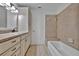 A bathroom features a vanity with drawers and cabinets, a decorative mirror and a tub at 8710 54Th W Ave # 8710, Bradenton, FL 34210