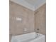 A bathroom features a bathtub and tiled walls at 8710 54Th W Ave # 8710, Bradenton, FL 34210