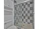Bathroom featuring a walk-in shower with blue and white checkered tile at 8710 54Th W Ave # 8710, Bradenton, FL 34210