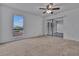 Bright bedroom with a ceiling fan, a sliding glass door leading to a sunroom, and a large window at 8710 54Th W Ave # 8710, Bradenton, FL 34210