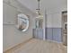 Dining area with grey cabinets, white walls, a round window, and wood-look tile floors at 8710 54Th W Ave # 8710, Bradenton, FL 34210