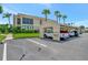 View of a condo building with covered parking and lush green space and mature landscaping at 8710 54Th W Ave # 8710, Bradenton, FL 34210