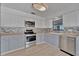 Updated kitchen featuring sleek stainless appliances, light countertops, and stylish tile backsplash at 8710 54Th W Ave # 8710, Bradenton, FL 34210