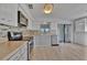 Updated kitchen with stainless steel appliances, tile backsplash, light countertops, and wood-look floors at 8710 54Th W Ave # 8710, Bradenton, FL 34210