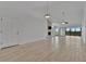 Open living room with vaulted ceiling, tile floors, and a slider to screened balcony at 8710 54Th W Ave # 8710, Bradenton, FL 34210