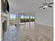 Open living space boasting tile flooring, a fireplace, and sliding glass doors to the screened-in balcony at 8710 54Th W Ave # 8710, Bradenton, FL 34210
