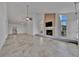 Spacious living room featuring neutral tile, a brick fireplace, and arched windows for abundant natural light at 8710 54Th W Ave # 8710, Bradenton, FL 34210