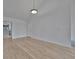 Bright, neutral living space featuring wood-look tile flooring and an open doorway to the kitchen at 8710 54Th W Ave # 8710, Bradenton, FL 34210