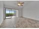Open living room featuring a ceiling fan, tile flooring, and sliding glass doors to the lanai at 8710 54Th W Ave # 8710, Bradenton, FL 34210