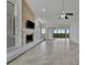 Inviting living space featuring a fireplace, ceiling fan, and access to a screened balcony at 8710 54Th W Ave # 8710, Bradenton, FL 34210
