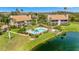 Community pool with landscaped grounds and a lake, offering a perfect blend of relaxation and outdoor enjoyment at 8710 54Th W Ave # 8710, Bradenton, FL 34210