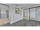 Bright sunroom featuring gray wood-look floors, white cabinets, and sliding glass doors to another room at 8710 54Th W Ave # 8710, Bradenton, FL 34210