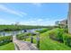 Scenic waterfront view with lush landscaping, boat docks, and stairs leading to the waterway and gorgeous blue sky at 8710 54Th W Ave # 8710, Bradenton, FL 34210