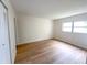 Inviting bedroom with laminate flooring, a neutral color scheme, and a large window at 970 Virginia St # 109, Dunedin, FL 34698
