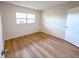 Bright bedroom featuring hardwood floors and a window for natural light at 970 Virginia St # 109, Dunedin, FL 34698