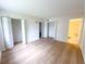 Bedroom with hardwood floors, and two walk-in closets with bi-fold doors at 970 Virginia St # 109, Dunedin, FL 34698