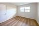 Bedroom with hardwood floors and a bright window for natural lighting at 970 Virginia St # 109, Dunedin, FL 34698