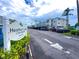 Heather Lake Condominiums with a community sign, and lush landscaping at 970 Virginia St # 109, Dunedin, FL 34698