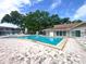 Community pool with lounge chairs and a fenced in area at 970 Virginia St # 109, Dunedin, FL 34698