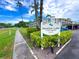 Heather Lake Condominium Community Sign showing lush greenery and landscaping at 970 Virginia St # 109, Dunedin, FL 34698