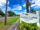Heather Lake Condominium Community sign with lush landscaping at 970 Virginia St # 109, Dunedin, FL 34698